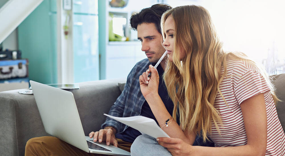 Couple reviewing their credit rating on a laptop
